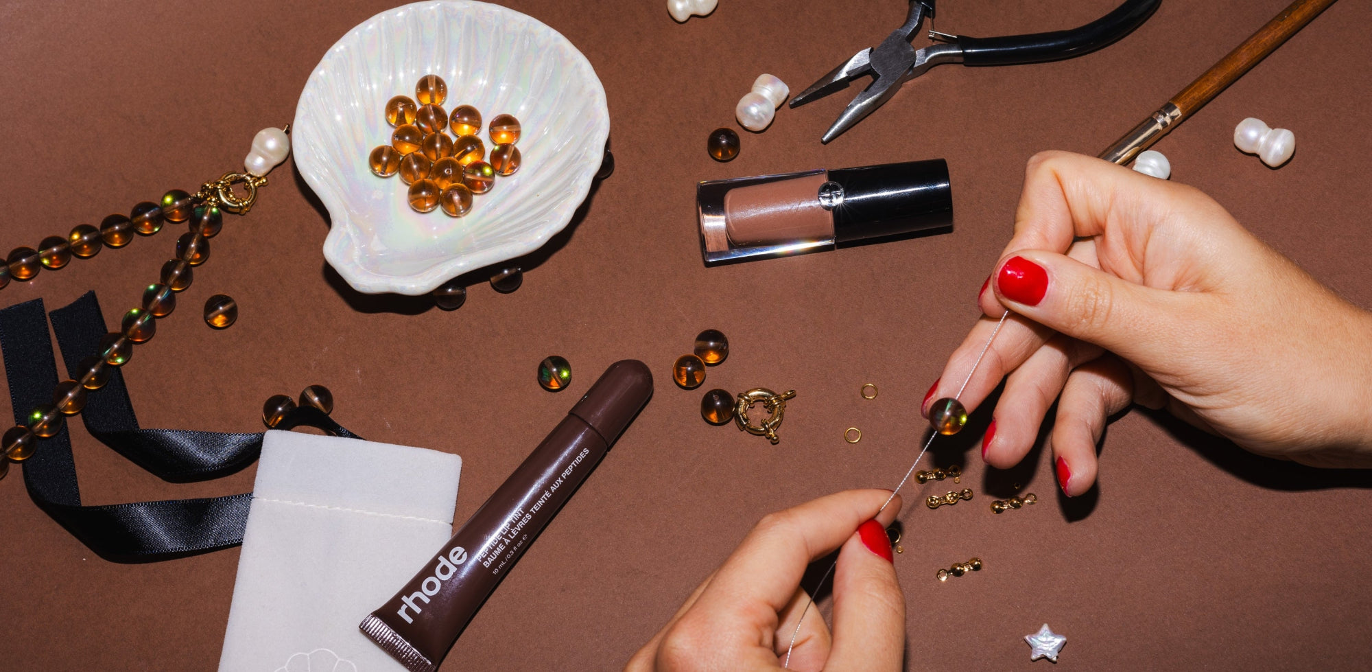 Person making jewelry with gemstone beads