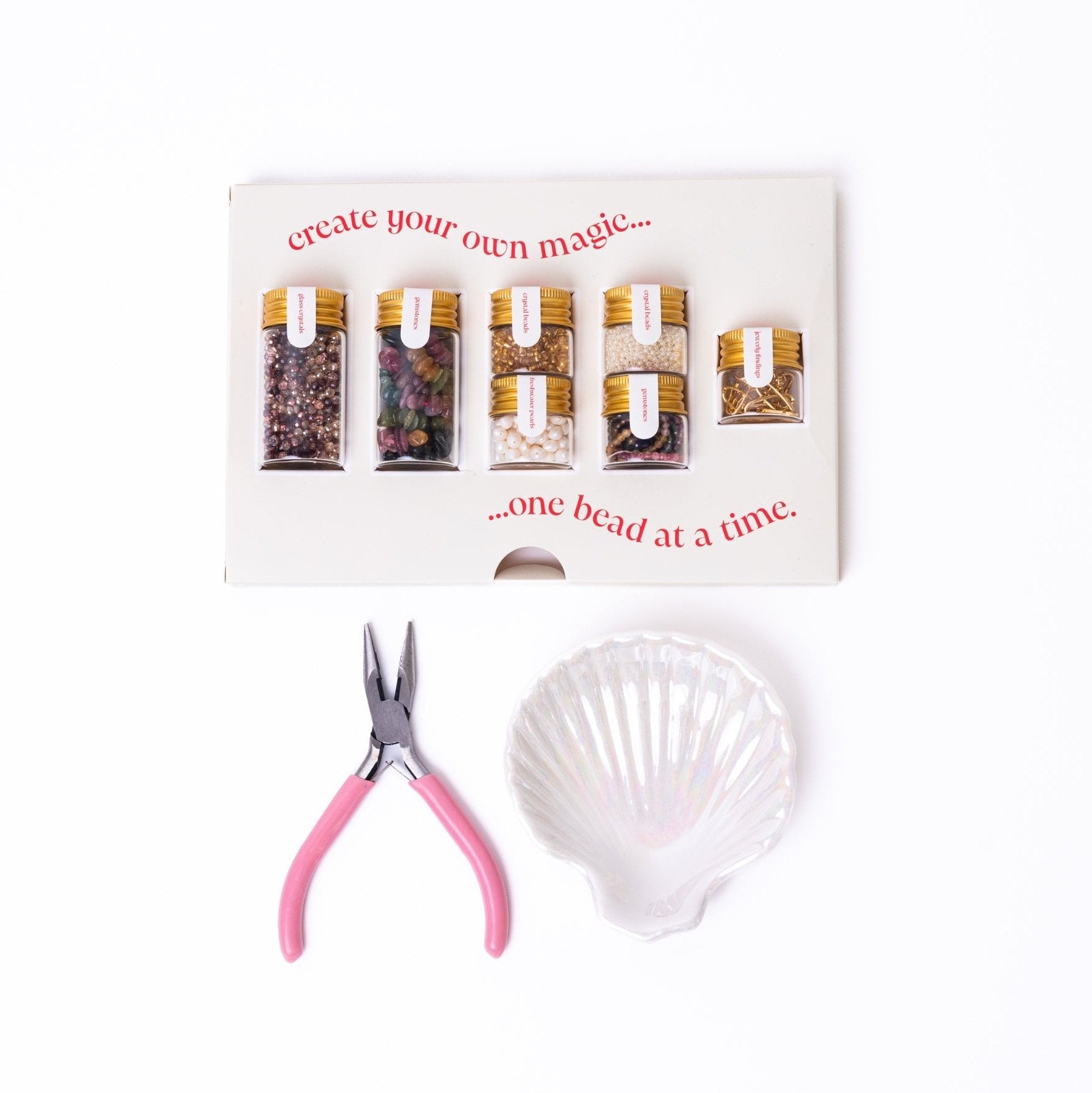 Mother Earth DIY Jewelry Kit by Nacre Creative with tourmaline gemstones, freshwater pearls, crystal beads, 18k gold-plated clasps, pink-handled pliers, and shell bowl for luxury necklace making.
