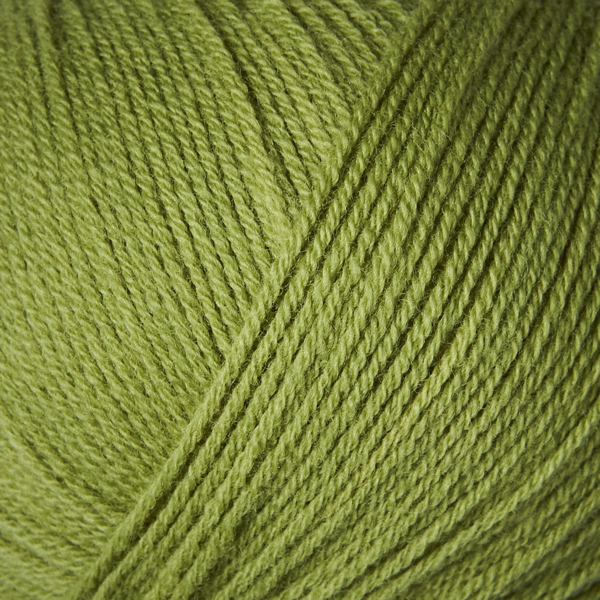 Close-up of Knitting for Olive Merino yarn in Pea Shoots