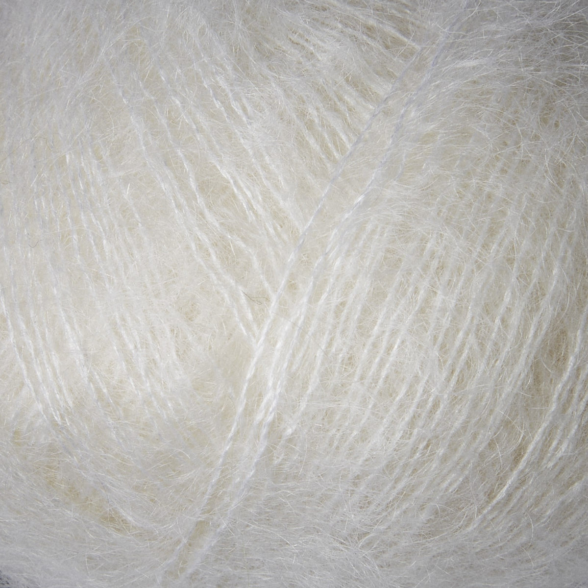 Close-up of Knitting for Olive Soft Silk Mohair yarn in Snowflake