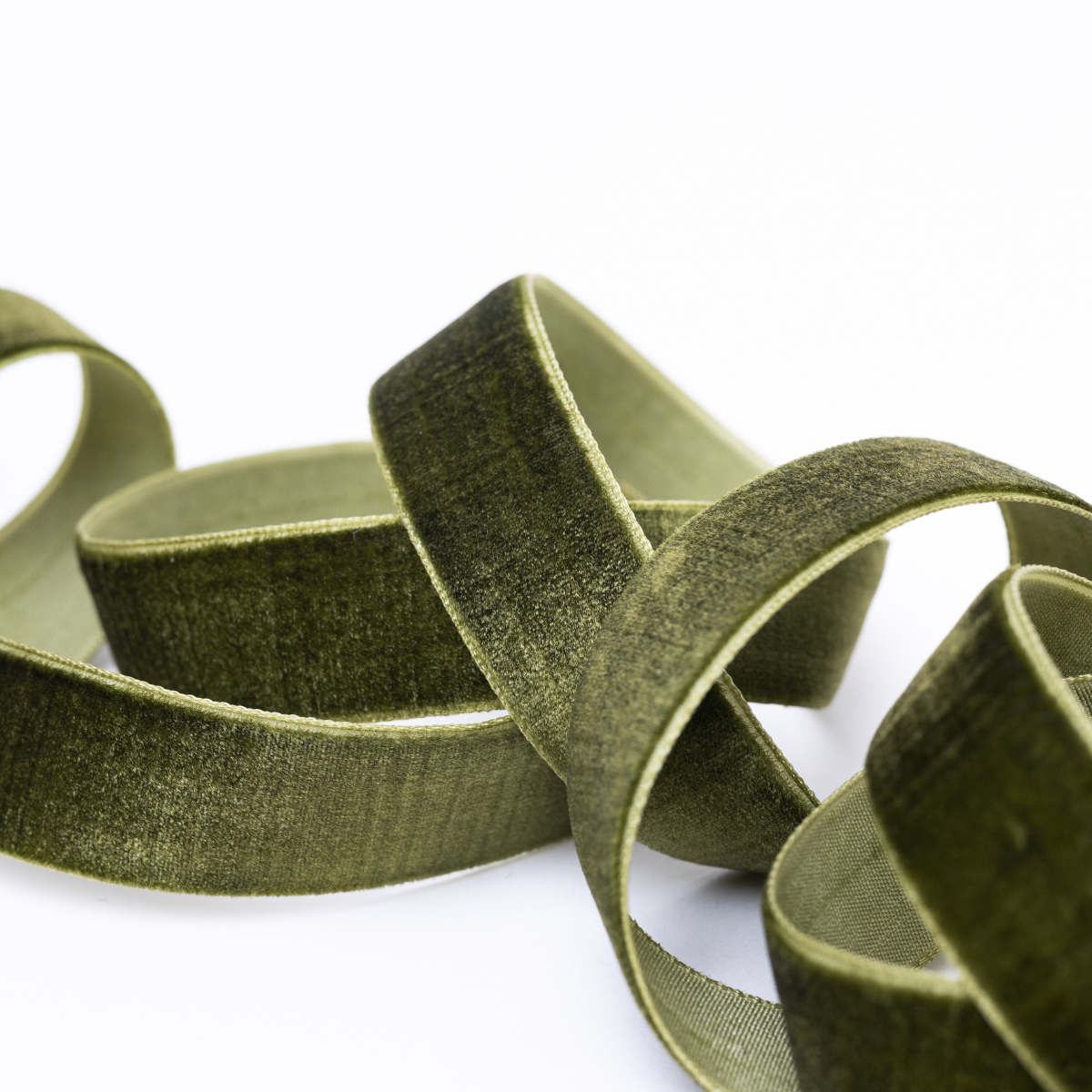 Green velvet ribbon on a white background